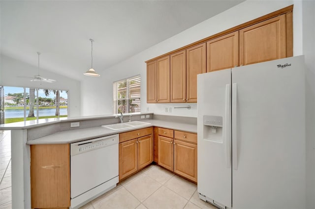 kitchen featuring white appliances, a peninsula, light countertops, a sink, and light tile patterned flooring