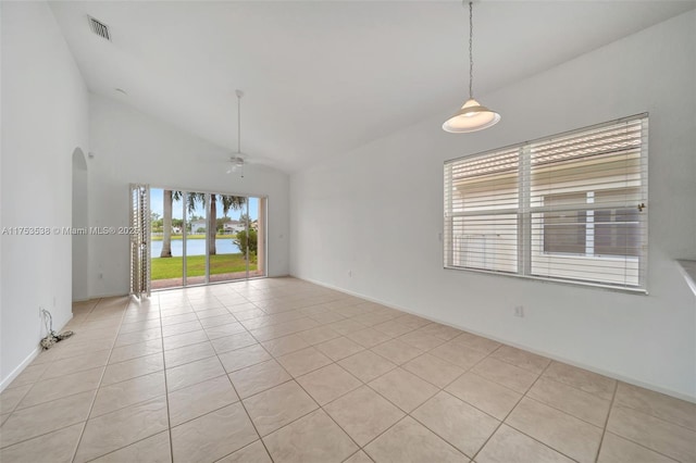 unfurnished room featuring light tile patterned floors, visible vents, arched walkways, ceiling fan, and a water view