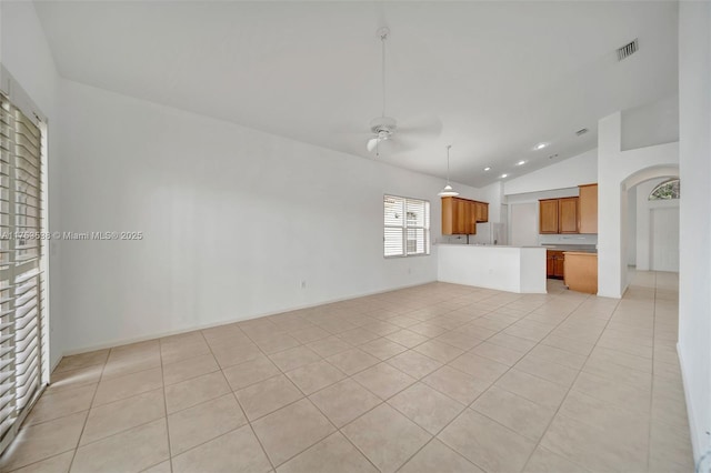 unfurnished living room with light tile patterned floors, visible vents, vaulted ceiling, and a ceiling fan