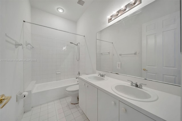 full bath featuring toilet, a sink, visible vents, and tile patterned floors