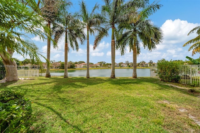 view of yard featuring a water view and fence