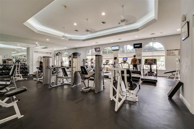 gym with recessed lighting, a raised ceiling, visible vents, and baseboards