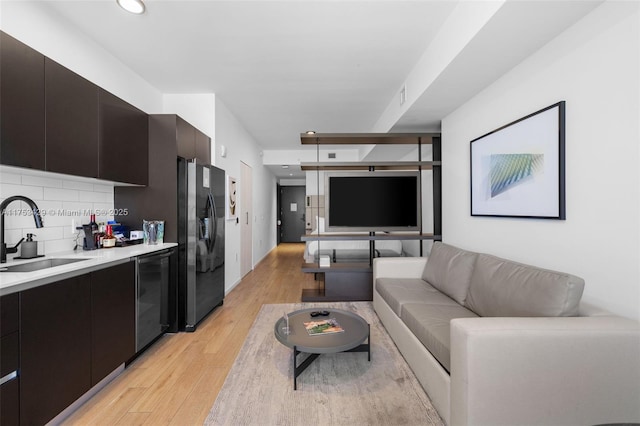 living room with wine cooler, visible vents, light wood finished floors, and recessed lighting