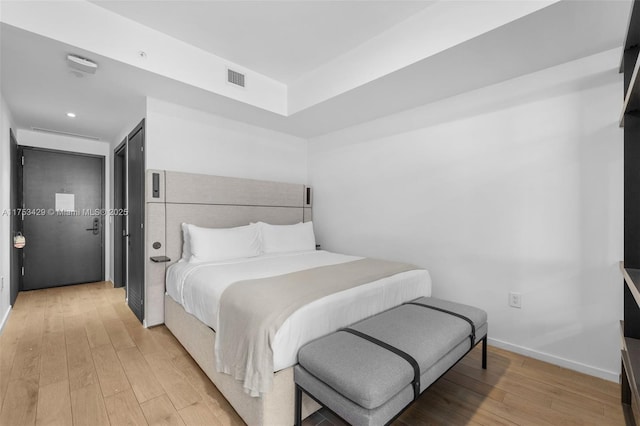 bedroom with recessed lighting, visible vents, light wood-style flooring, and baseboards