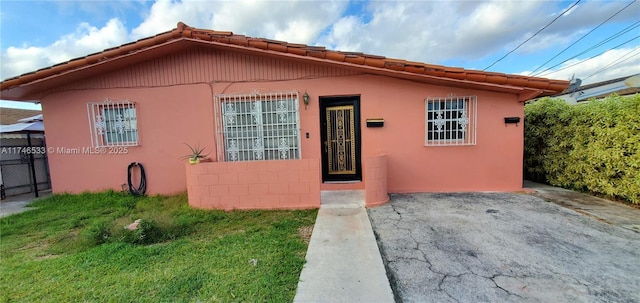 view of front of property featuring fence and stucco siding