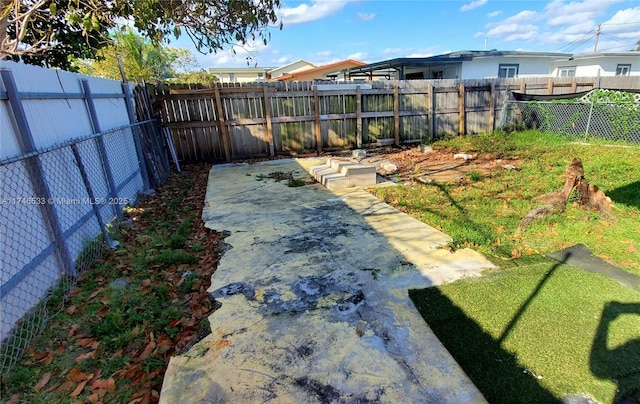 view of yard featuring a patio and a fenced backyard