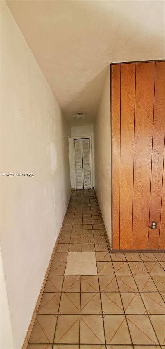 hallway featuring light tile patterned floors