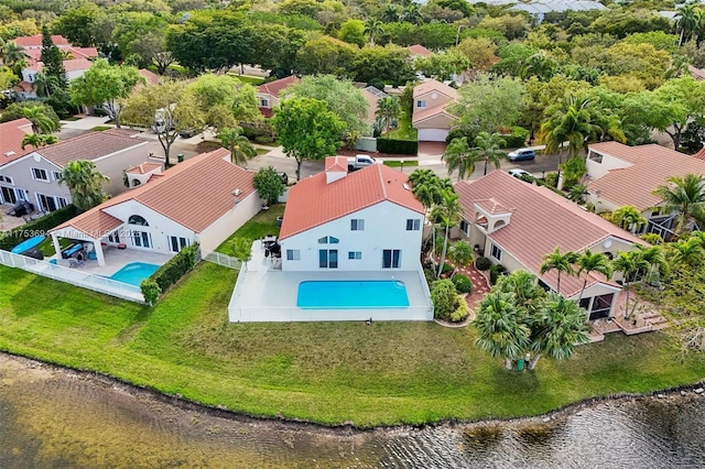 drone / aerial view with a water view and a residential view