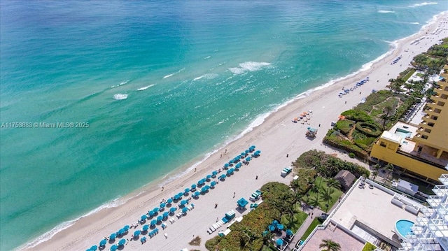 drone / aerial view featuring a view of the beach and a water view