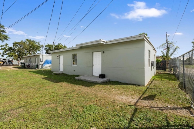 back of property with fence and a yard