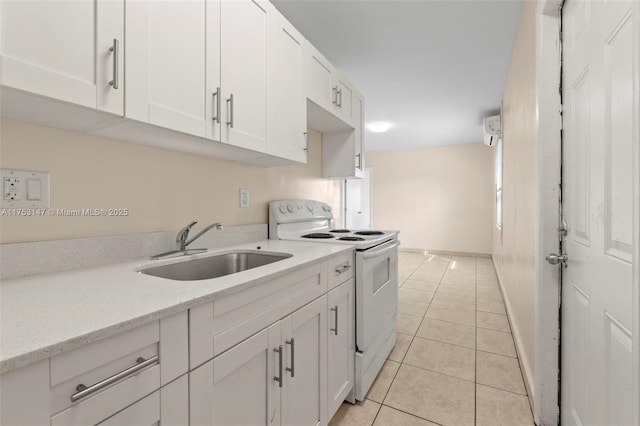 kitchen featuring white electric range, white cabinetry, a sink, light tile patterned flooring, and light stone countertops