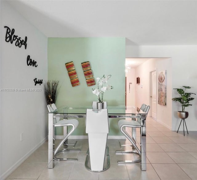 dining area featuring baseboards and tile patterned floors