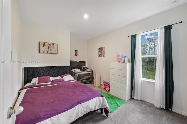 carpeted bedroom featuring baseboards