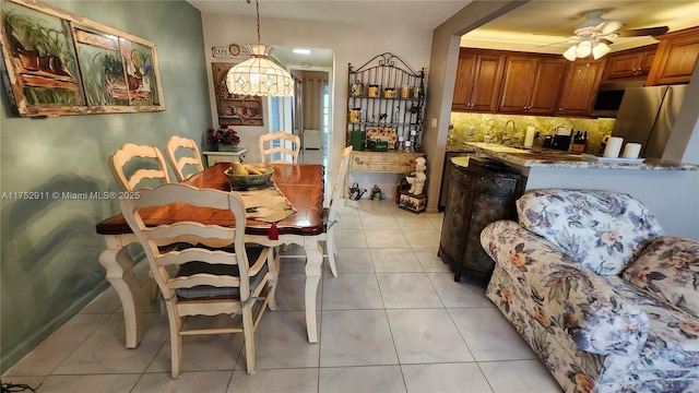 dining area featuring light tile patterned floors and a ceiling fan