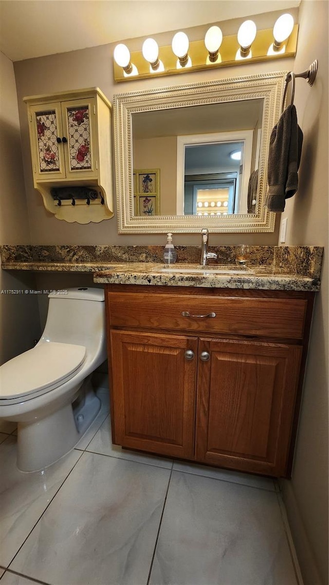 half bathroom featuring toilet and vanity