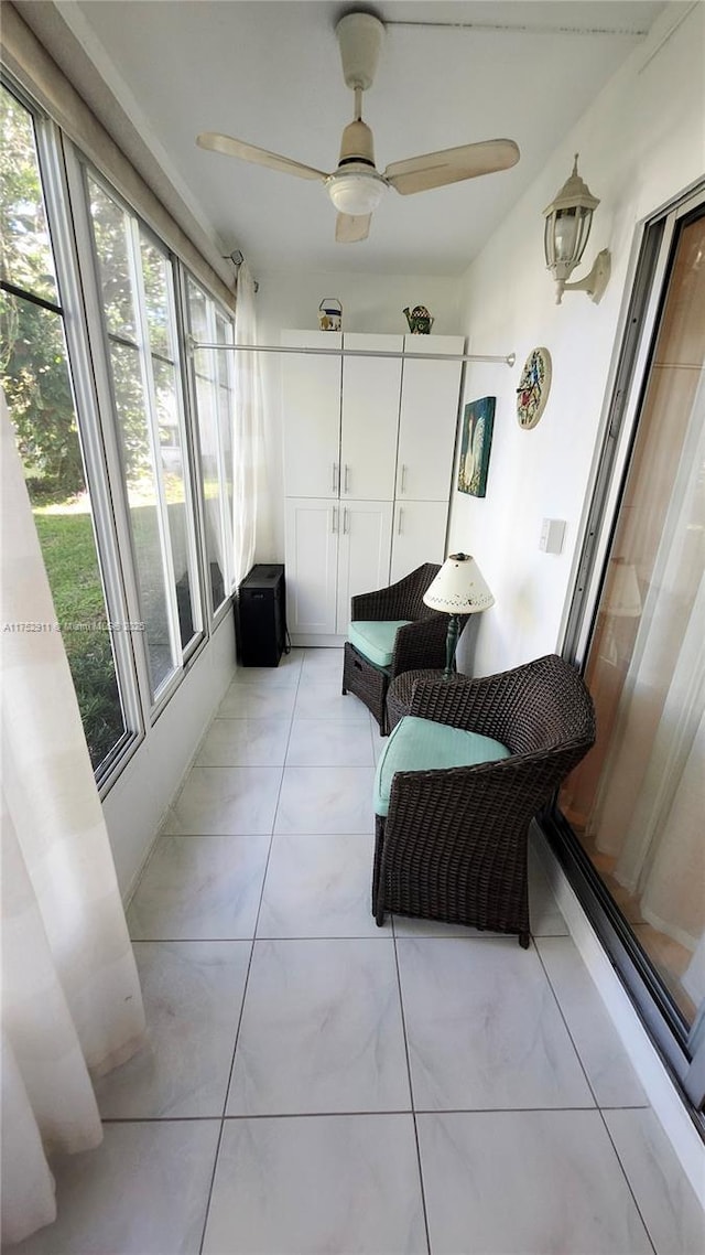 sunroom featuring ceiling fan