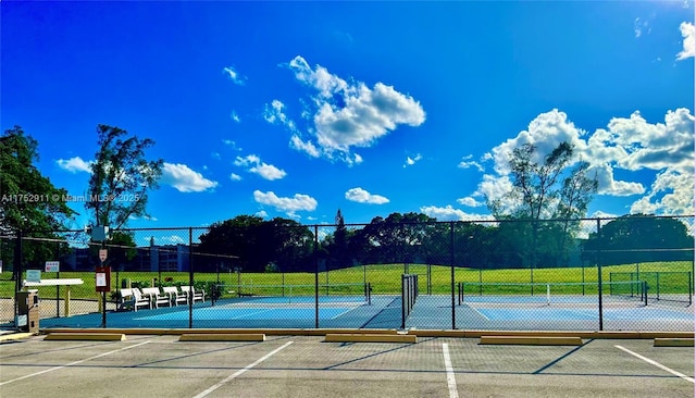 view of tennis court featuring fence