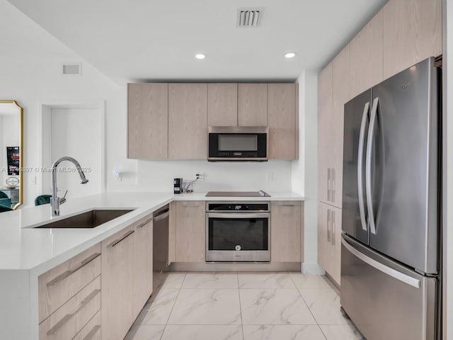 2000 Metropica Way Unit 1507, Sunrise, FL 33323 - kitchen featuring light brown cabinets, a sink, marble finish floor, appliances with stainless steel finishes, and light countertops