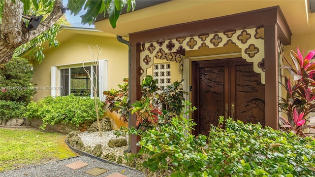 entrance to property featuring stucco siding