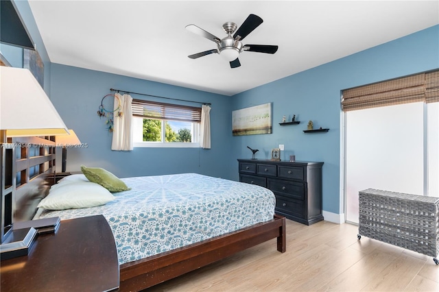 bedroom featuring baseboards, a ceiling fan, and wood finished floors