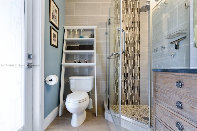 bathroom with a shower stall and toilet