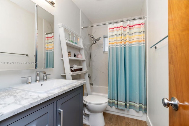 bathroom featuring toilet, shower / bath combo with shower curtain, wood finished floors, and vanity