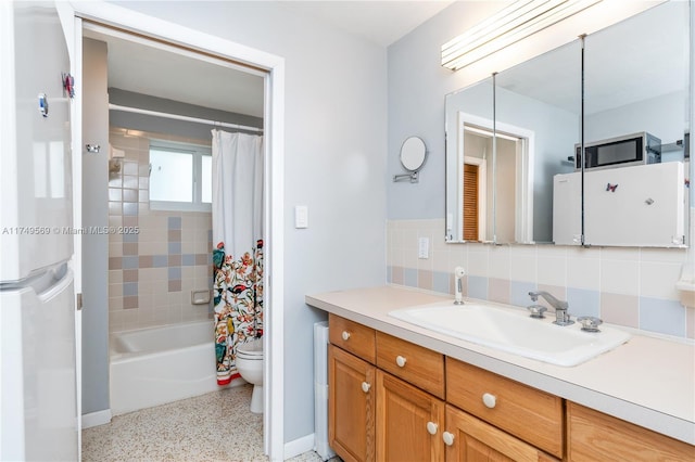 full bathroom with toilet, speckled floor, vanity, tasteful backsplash, and shower / bath combo with shower curtain