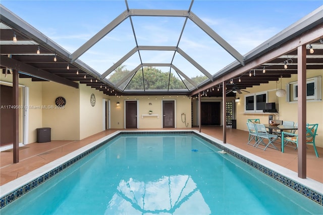 outdoor pool with a patio and a ceiling fan