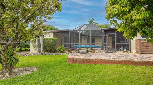 view of yard featuring glass enclosure and a patio area