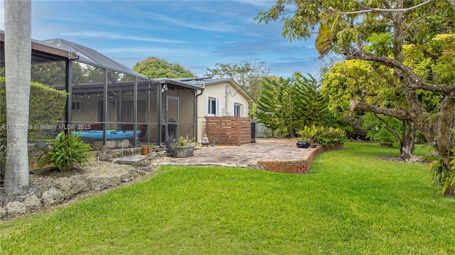 view of yard featuring a patio area and glass enclosure