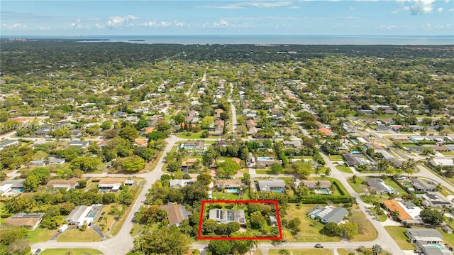 bird's eye view featuring a residential view and a water view