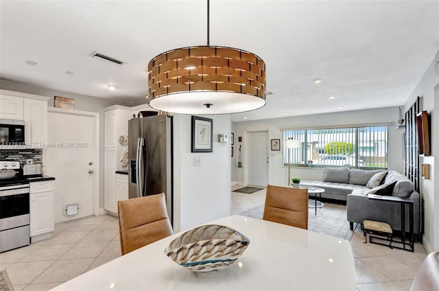 dining space with light tile patterned flooring, recessed lighting, and visible vents