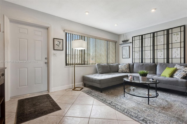 living room featuring light tile patterned floors, baseboards, and recessed lighting