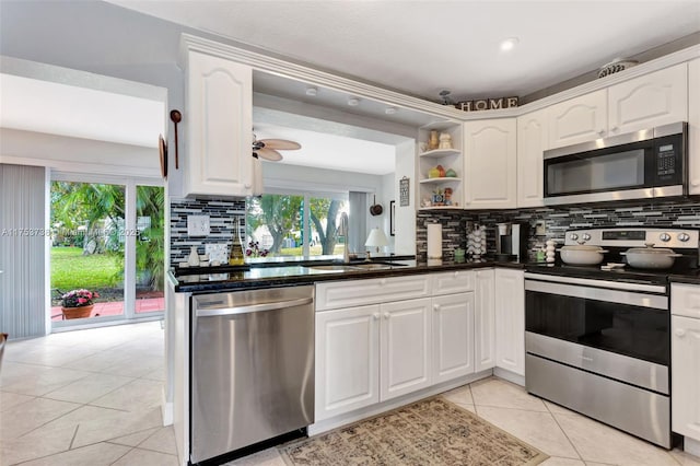 6820 NW 17th Ct, Margate, FL 33063 - kitchen with open shelves, a sink, appliances with stainless steel finishes, white cabinetry, and dark countertops