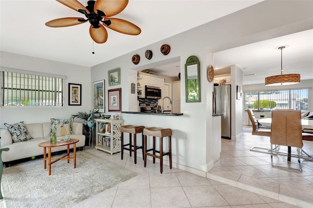 6820 NW 17th Ct, Margate, FL 33063 - living area with light tile patterned floors, baseboards, and ceiling fan