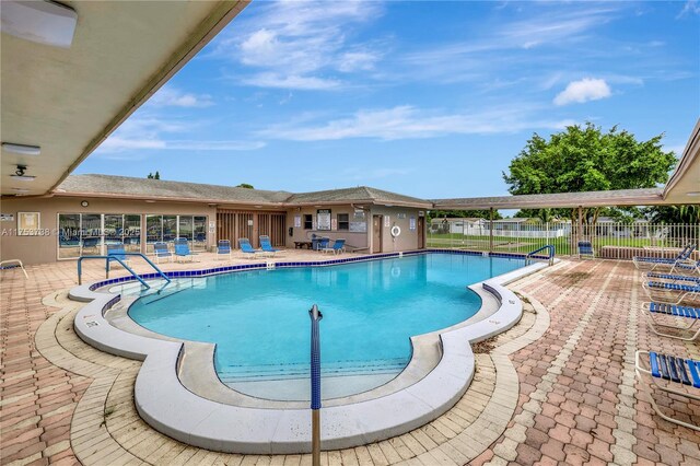 6820 NW 17th Ct, Margate, FL 33063 - community pool featuring a patio area and fence