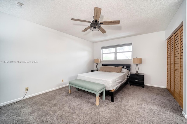 bedroom with a ceiling fan, carpet flooring, a textured ceiling, and baseboards