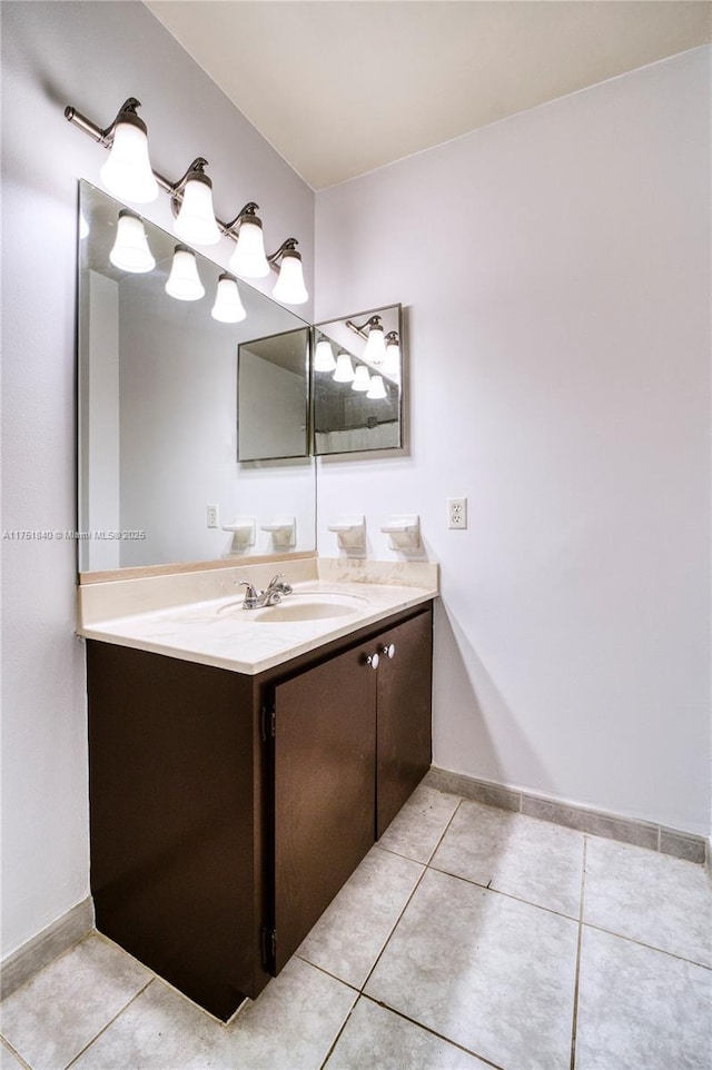 bathroom featuring tile patterned flooring, vanity, and baseboards