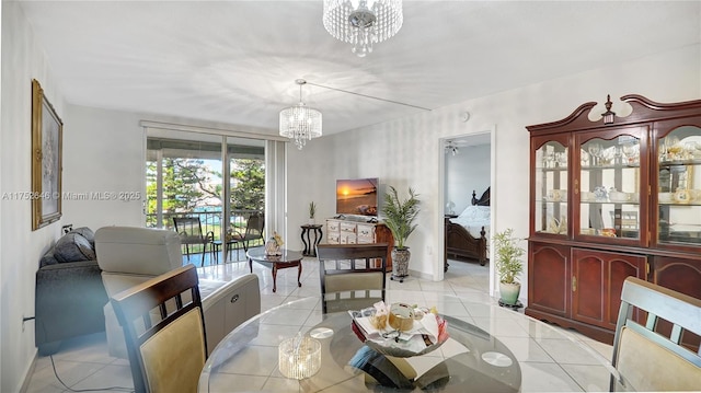 dining space with a notable chandelier, baseboards, and light tile patterned floors