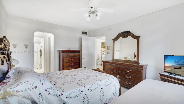 bedroom featuring visible vents, arched walkways, and ceiling fan