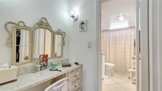 bathroom featuring toilet, a shower with curtain, tile patterned flooring, and vanity