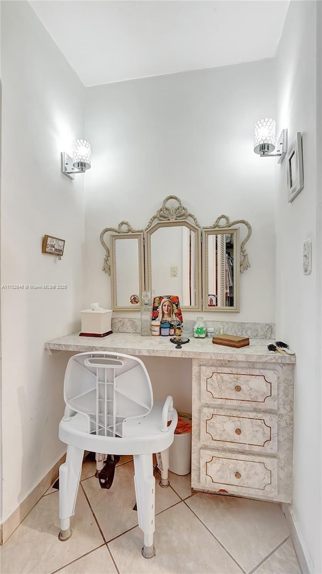 bathroom with tile patterned flooring and baseboards