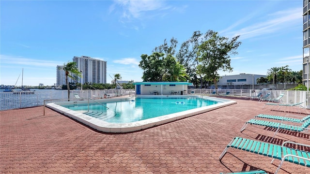 pool featuring fence and a patio