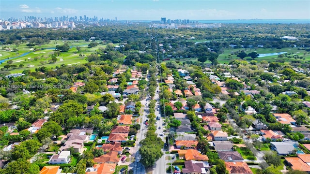 birds eye view of property featuring golf course view and a water view