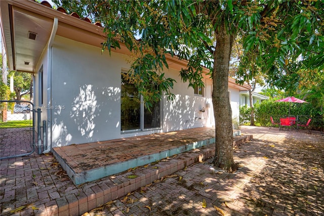 view of home's exterior featuring a patio area, fence, and stucco siding