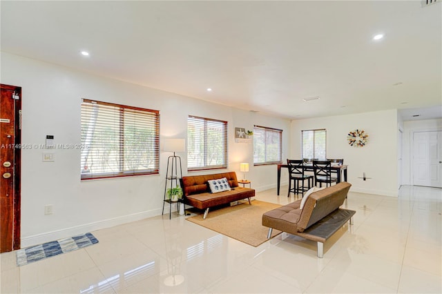 living area with recessed lighting, light tile patterned flooring, and baseboards