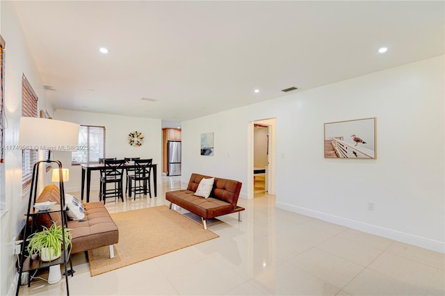 living area featuring recessed lighting, visible vents, and baseboards