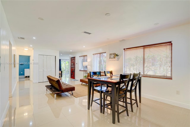 dining area featuring light tile patterned flooring, recessed lighting, visible vents, and baseboards