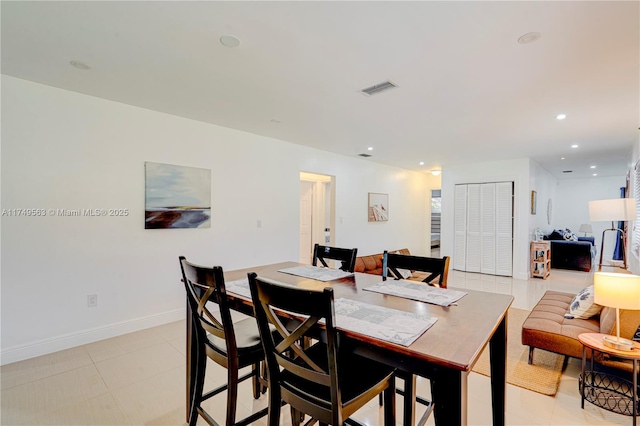 dining room with baseboards, light tile patterned flooring, visible vents, and recessed lighting