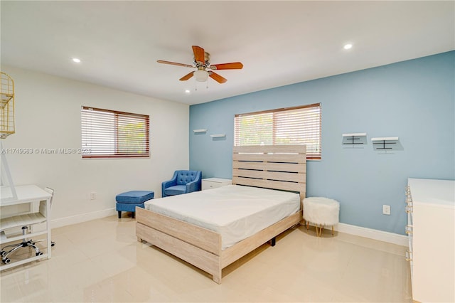 bedroom with light tile patterned floors, multiple windows, and baseboards